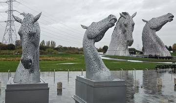 Artistic sculptures of horse heads in a park.