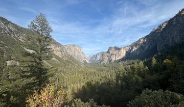 Wide view of Yosemite Valley with mountains and forests.