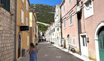 Picturesque street with colorful buildings and a view of a mountain.
