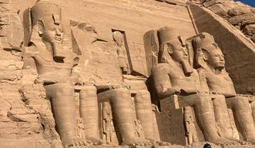 Massive rock-cut statues of Egyptian pharaohs.