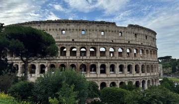 Colosseum in Rome with greenery in foreground.
