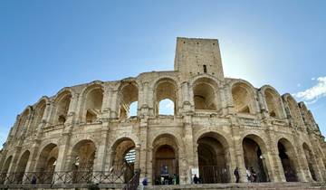Historical stone amphitheater under a clear blue sky.