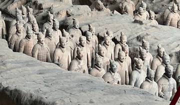 Terracotta Warriors in a large excavation pit.