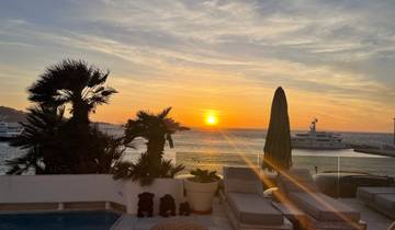 Sunset view overlooking a marina with yachts.