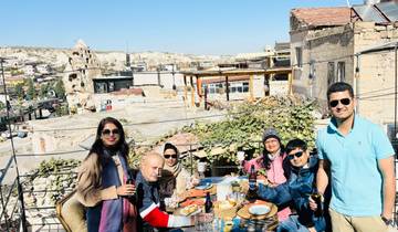 People enjoying food and drinks on a rooftop terrace.