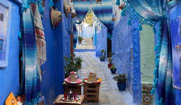 Colorful alleyway with blue walls and stalls in shopping street.