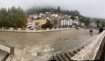 Foggy view of a town with colorful houses.