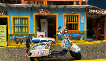 Colorful street facade with a vibrant scooter in front.
