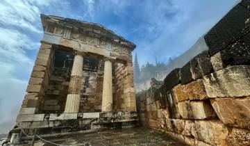 Ancient ruins with columns and stone walls under a blue sky.