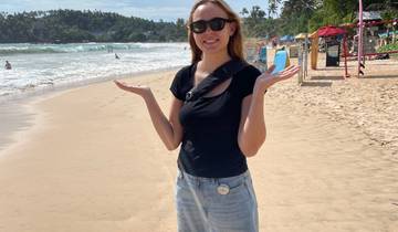 Person posing on a beach.