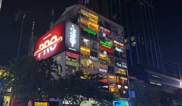 Building with bright neon signs at night.