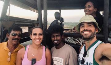 A group of people in an open-top safari vehicle.