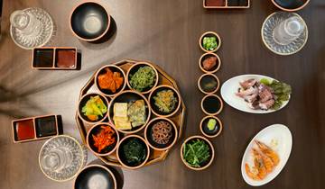 Traditional Korean meal with various side dishes on a table.