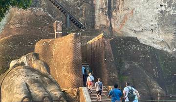 People ascending the ancient rock fortress.