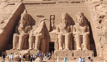 Temple of Abu Simbel with large statues and tourists.