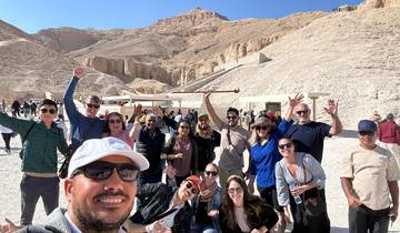 Large group of diverse tourists at an archaeological site.