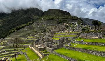 Iconic terraced structure of Machu Picchu with mountains in the background.