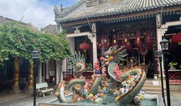 Dragon sculpture in front of a pagoda.