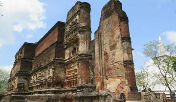 Ruins of an ancient brick and stone building under a clear sky.