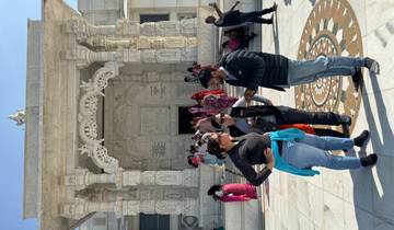 Tourists gathered in front of a grand temple facade.