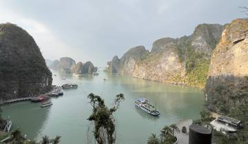 Scenic view of a bay with boats and karst limestone islands.