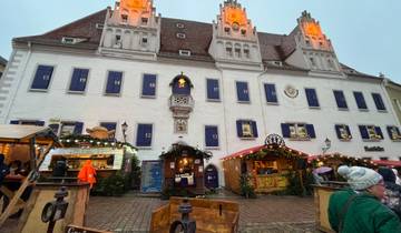 Building with Christmas market stalls and advent windows