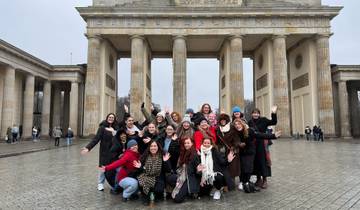 Large group cheering in front of the Brandenburg Gate