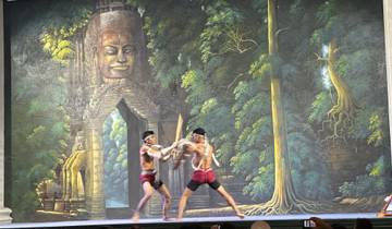 Two performers engaged in a traditional martial arts performance in front of a mural.