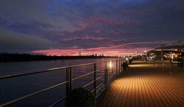 Sunset view from a deck overlooking a river.