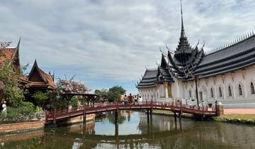 A traditional Thai architectural structure with a bridge over a pond.