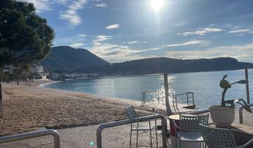 Peaceful beach with mountains in the background.