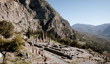 Archeological site of Delphi with mountainous backdrop.