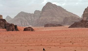 Vast desert landscape with mountain backdrops.