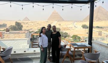 Group posing on a rooftop with views of the Pyramids.