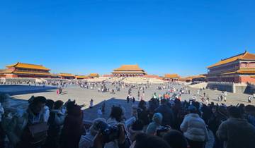 A large plaza with crowds gathered in front of historic Chinese architecture.