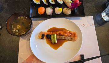 Japanese dishes including sushi and grilled salmon.