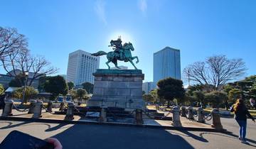 Equestrian statue with skyscrapers in the background.