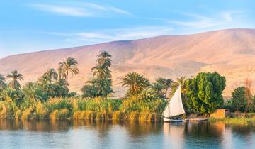 Landscape with a river, boat, and mountains in the background.