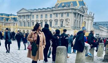 People standing in front of a historic palace entrance.