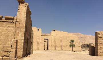 Exterior of a large ancient temple with clear blue sky.