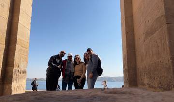 Group photo at historic columns with a scenic background.