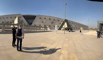 Exterior of a modern museum with visitors outside.