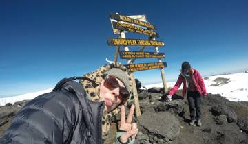 People celebrating at the summit of Mount Kilimanjaro.