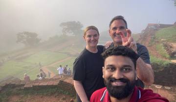 Selfie of three people on a misty morning on a hill.