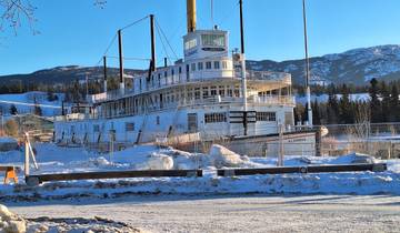 Historic steamship docked in a snowy environment.