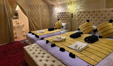 Interior of a luxury tent with twin beds.