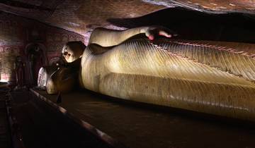 Large reclining Buddha statue inside an ancient temple.