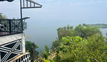 View of a lake surrounded by trees from a balcony