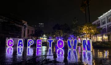 Cape Town sign illuminated with colorful lights.