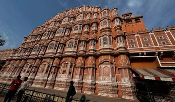 Hawa Mahal with its intricate facade and people walking past.
